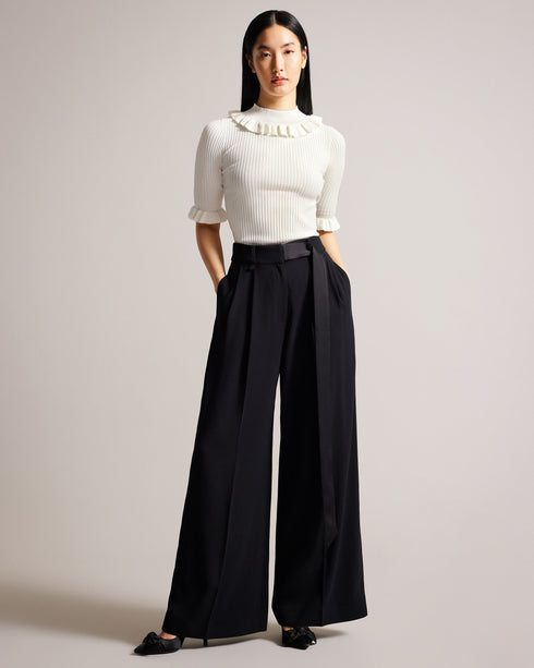 KATELLA-Knitwear-Made of stretchy knit, KATELLA is the perfect statement top to take you from season to season in style. With an oh-so-cute ruffle trim and a super soft feel, this fitted top is sure to become your new go-to. Ted Baker womenswear collection Fitted top Stretch fabric High neck Neck ruffle Ribbed knit Short sleeves with ruffle trim Amy is 5'9.5" / 1.77m and wears Black in a Ted size 1- Ted Baker Romania